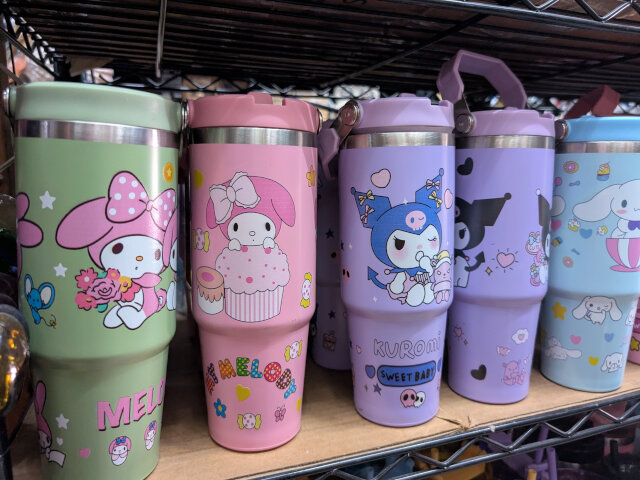 A row of Hello Kitty mugs.